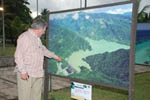 Businessman Chichi Selman points to one of the photos in the exhibit